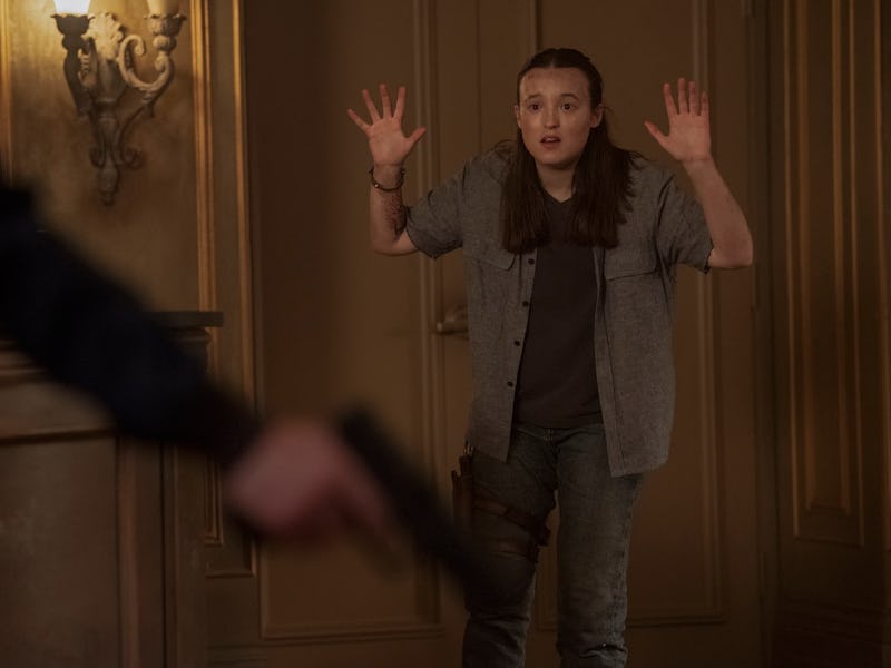 A person stands with their hands raised in a defensive gesture, appearing startled. In the foregroun...