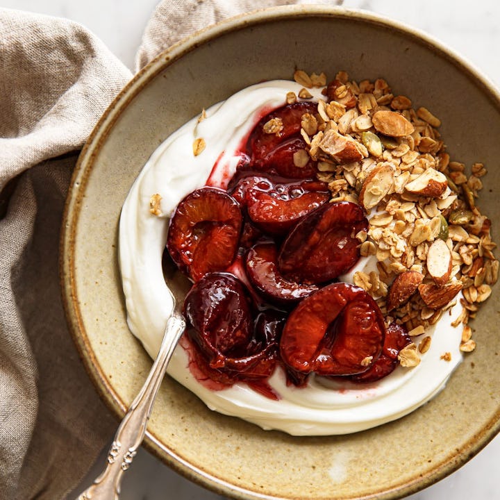 Roasted Plum Compote over yogurt in a bowl, in a story about recipes to use up greek yogurt