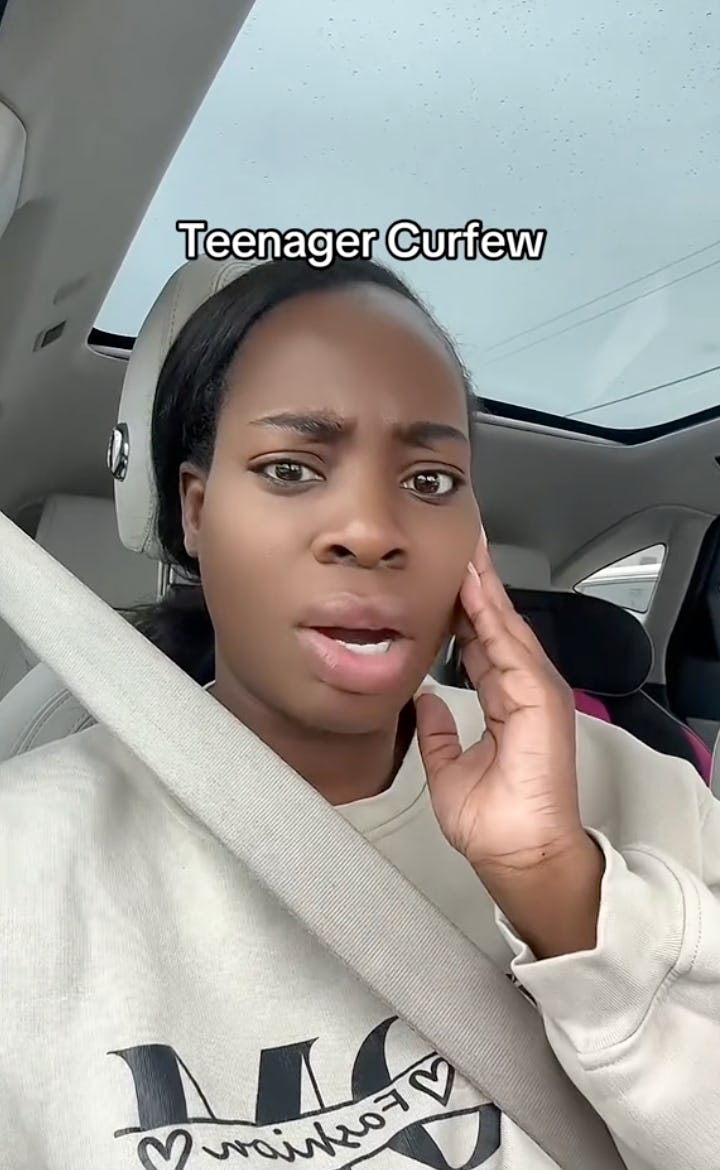 A young woman with dark hair in a car looks surprised or concerned, touching her face. The text above her reads "Teenager Curfew."