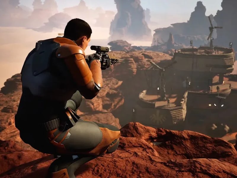 A player crouches on rocky terrain, aiming a weapon at a distant settlement surrounded by the rugged...