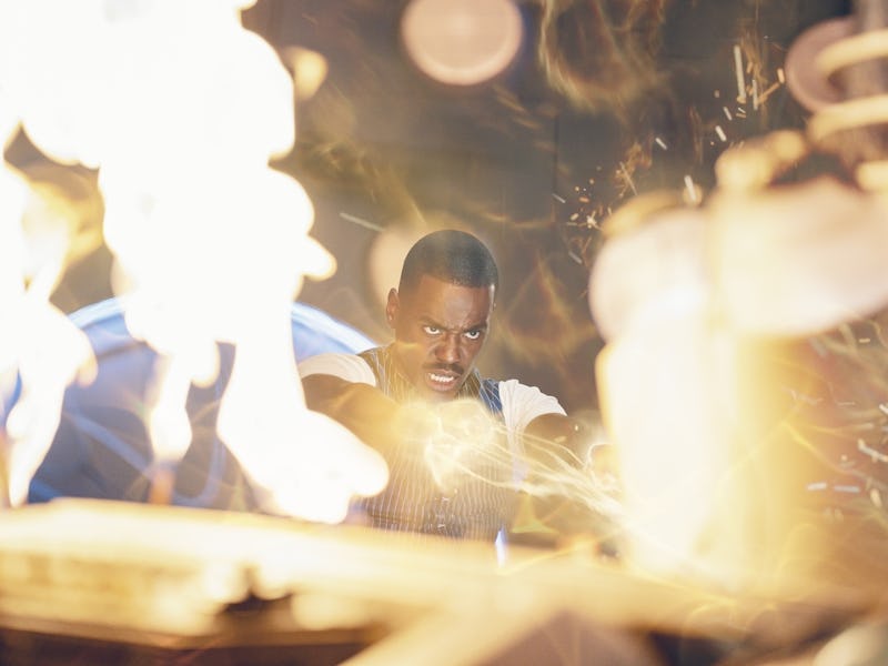 A focused individual works amidst bright sparks and flames, conveying intensity and concentration in...