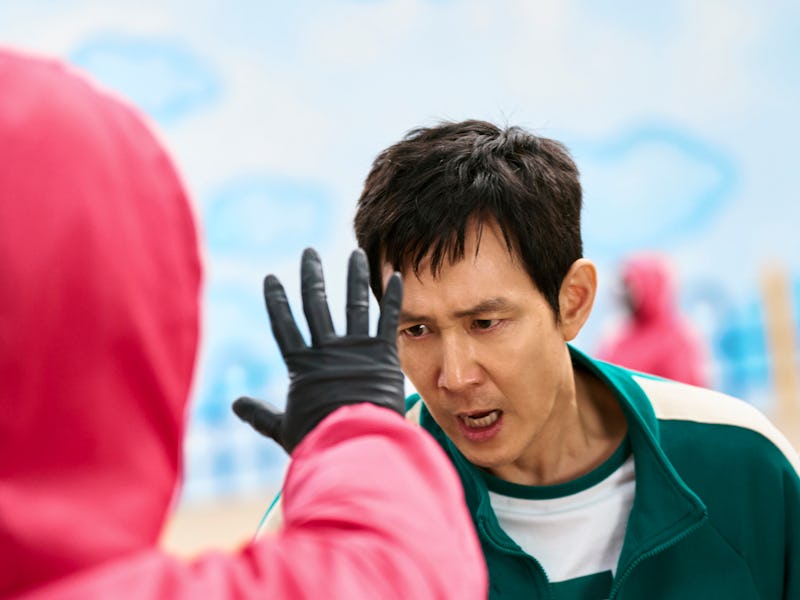 A tense moment unfolds as a man in a green tracksuit reacts passionately to a figure in a red outfit...