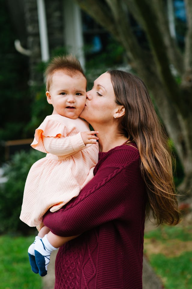 mom kisses baby