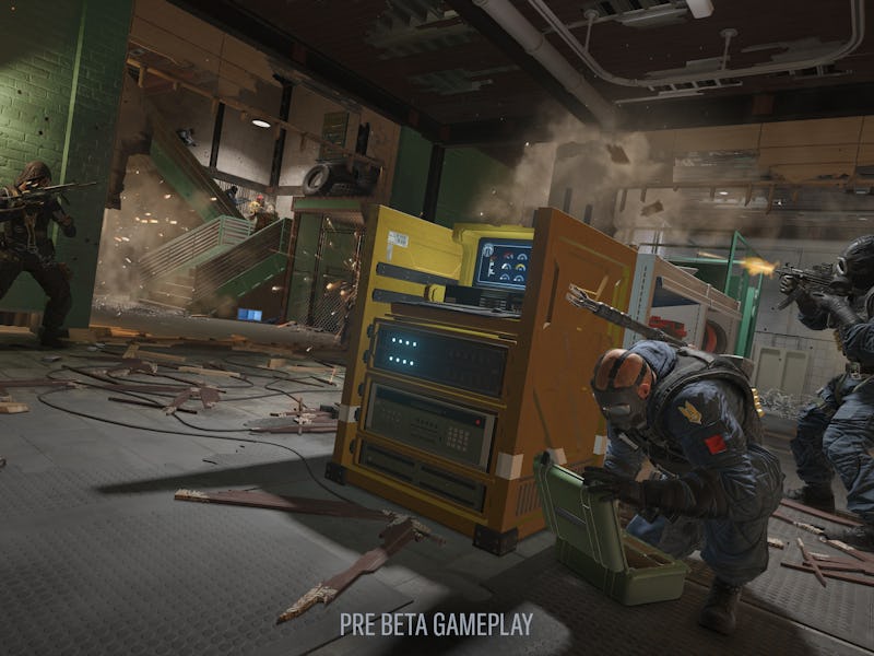 Two armed operators work on a control point while a third covers them.
