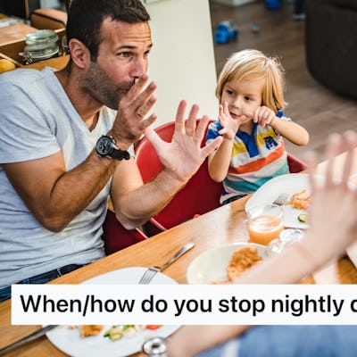 A father and young child sit at a dining table, playfully using hand gestures during dinner, while two others engaged in conversation nearby.