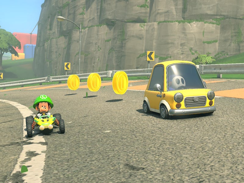 Baby Luigi drives next to a coin car.