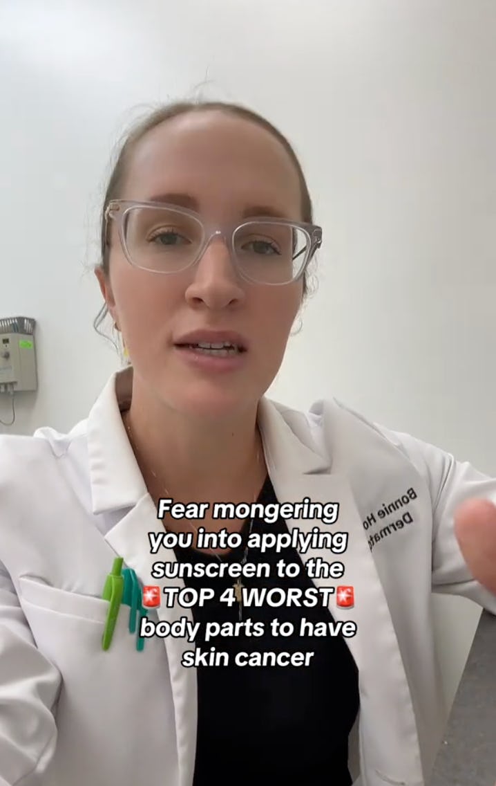 A woman in a lab coat speaks directly to the camera, emphasizing the importance of sunscreen. Text reads: "Fear mongering you into applying sunscreen to the TOP 4 WORST body parts to have skin cancer."