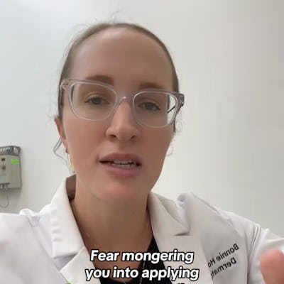 A woman in a lab coat speaks directly to the camera, emphasizing the importance of sunscreen. Text reads: "Fear mongering you into applying sunscreen to the TOP 4 WORST body parts to have skin cancer."