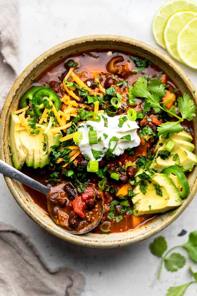 Sweet potato and black bean chili with cilantro and sour cream on top, in a story about black bean r...