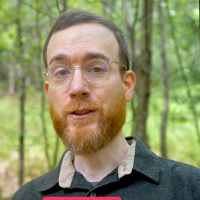 A man with glasses and a beard speaks in a wooded area, with text overlay reading "YOUR CAREGIVER'S JUDGMENTS." Green foliage surrounds him.
