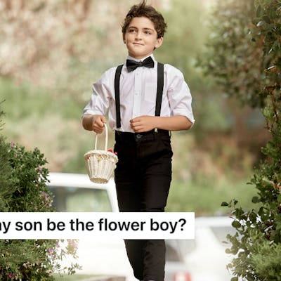 A young boy in a tuxedo and bow tie walks down a path, holding a small basket. Greenery surrounds him, creating a cheerful and festive atmosphere.