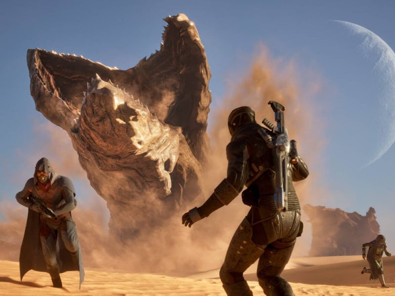 Players stare at a sandworm coming out of the ground.