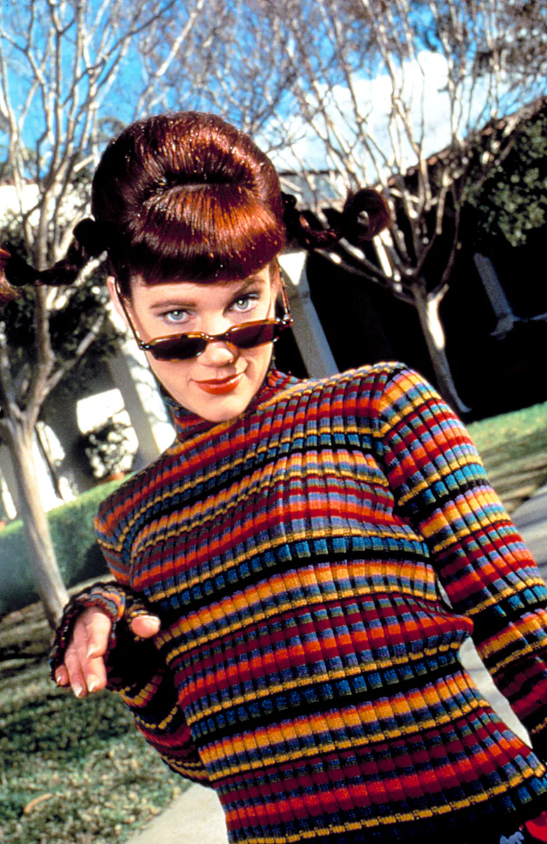 Clueless character Amber in a tight-striped rainbow turtleneck