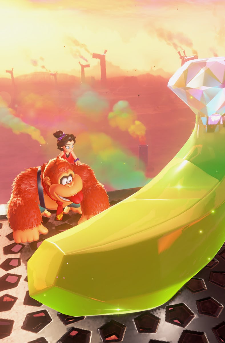 A character with brown fur and a hat sits on a platform next to a large, shiny green banana-shaped g...