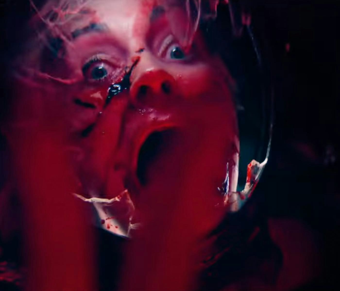 A distressed person with wide eyes and an open mouth appears trapped, surrounded by dark red hues, evoking a sense of fear and urgency.