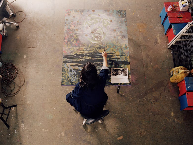 Nguyen working on a painting of Frankenstein