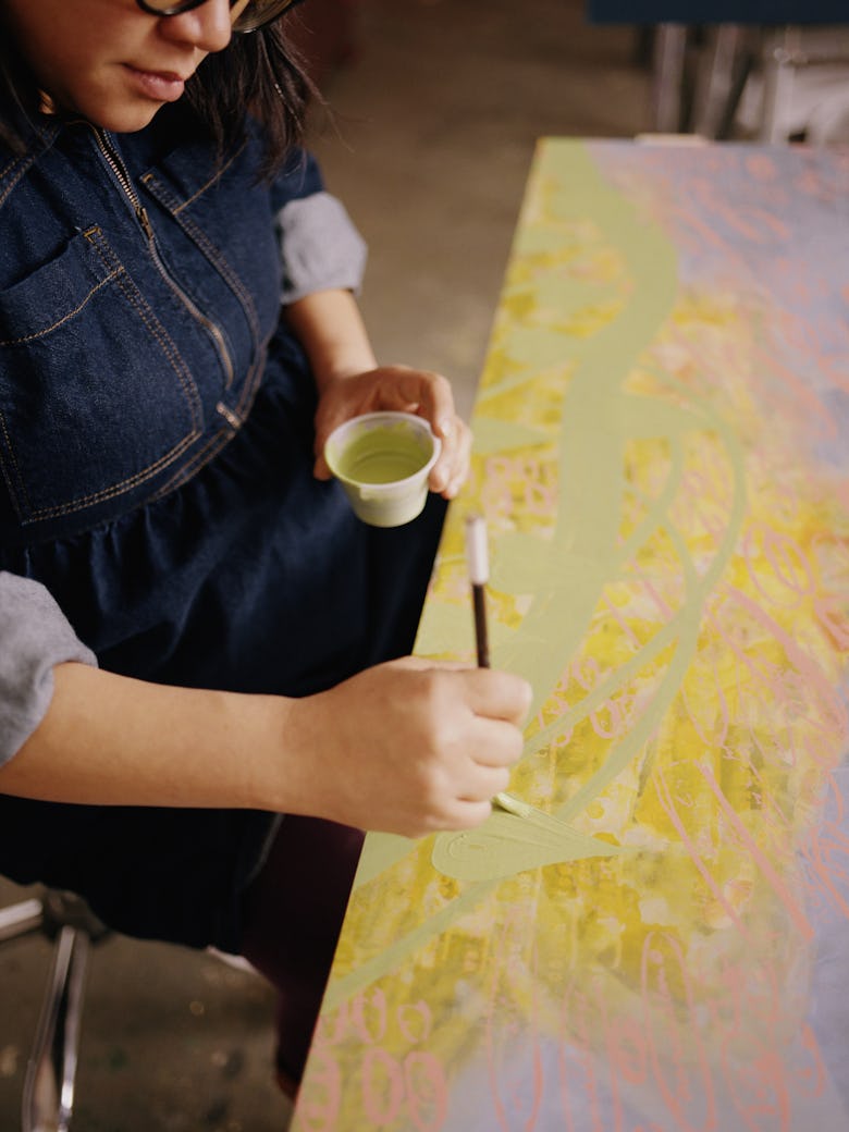 Nguyen painting in her studio
