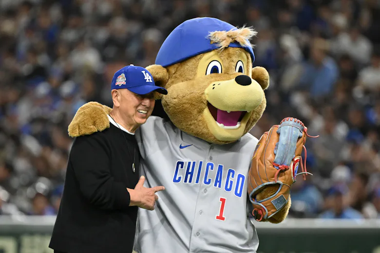 Chef Nobu Matsushita poses with Chicago Cubs mascot Clark the Cub after throwing the ceremonial firs...