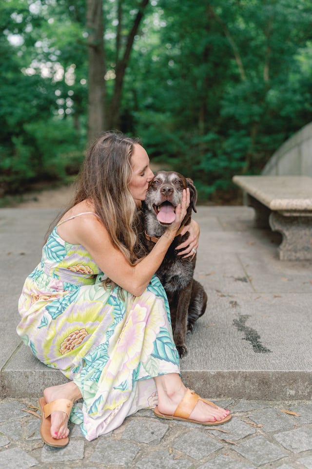 Writer Kait Hanson kisses her senior dog Judy in a heartwarming photo.