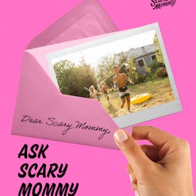 A group of kids playing with water guns in a backyard.