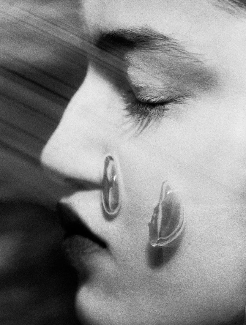a person with a couple glistening rose petals on their cheek