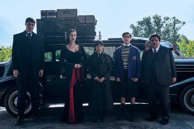 Wednesday. (L to R) Joonas Suotamo as Lurch, Catherine Zeta-Jones as Morticia Addams, Jenna Ortega a...