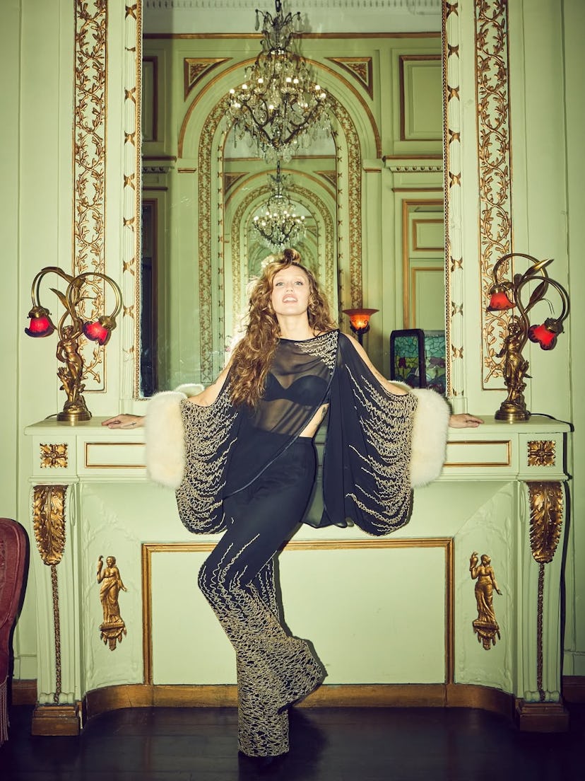 Miley Cyrus poses in an opulent room