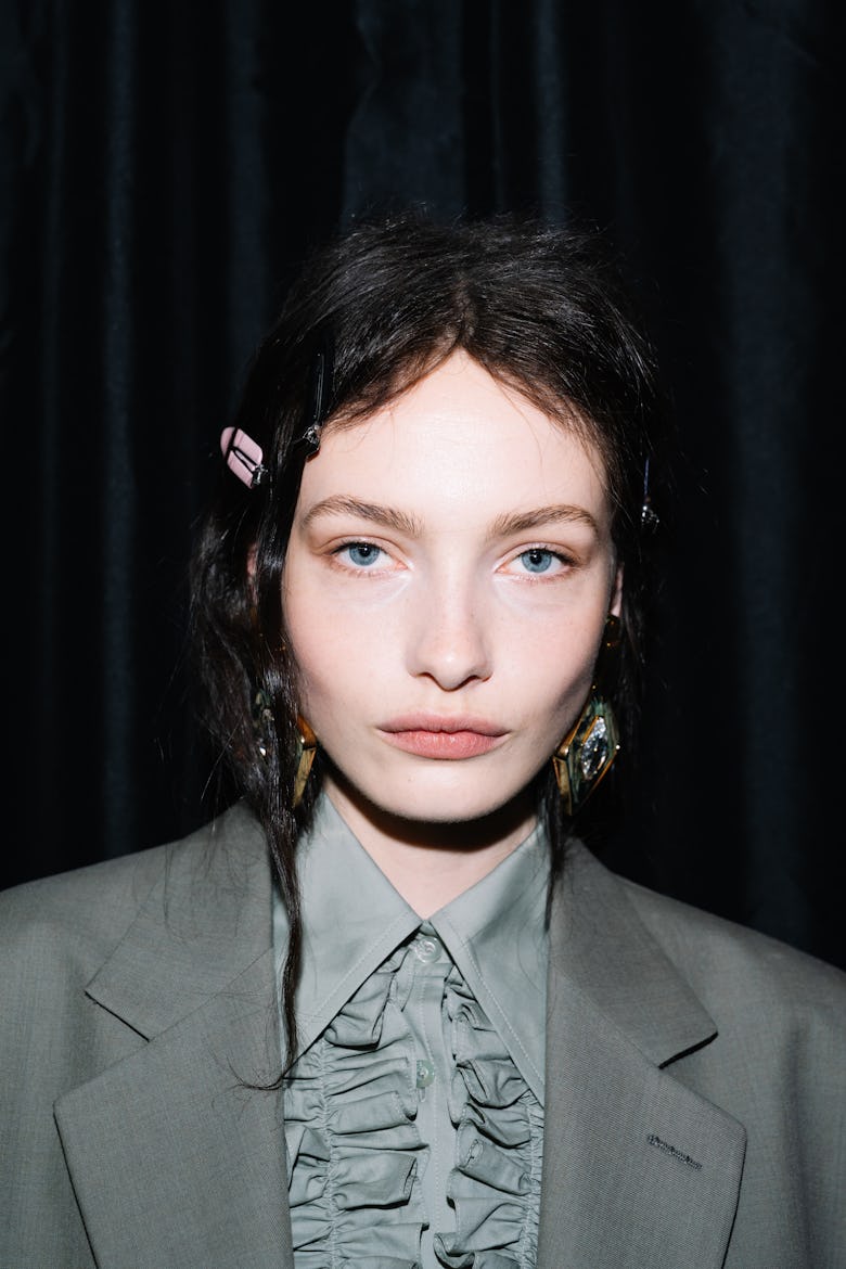 A model poses backstage at the Gucci Cruise 2026 fashion show at Gucci Archive on May 15, 2025 in Fl...