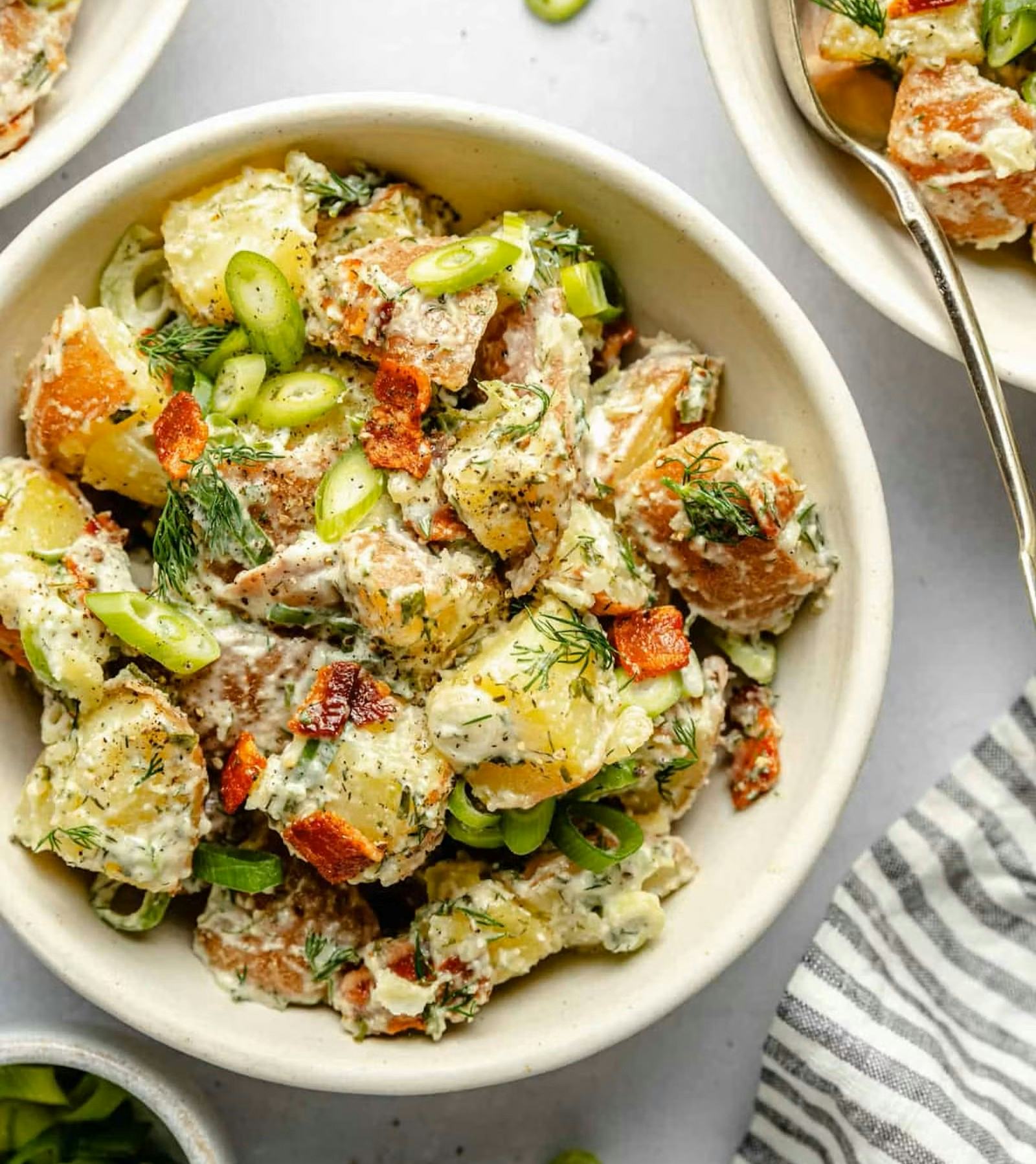 potato salad in a bowl, in a story about easy recipes to use up potatoes