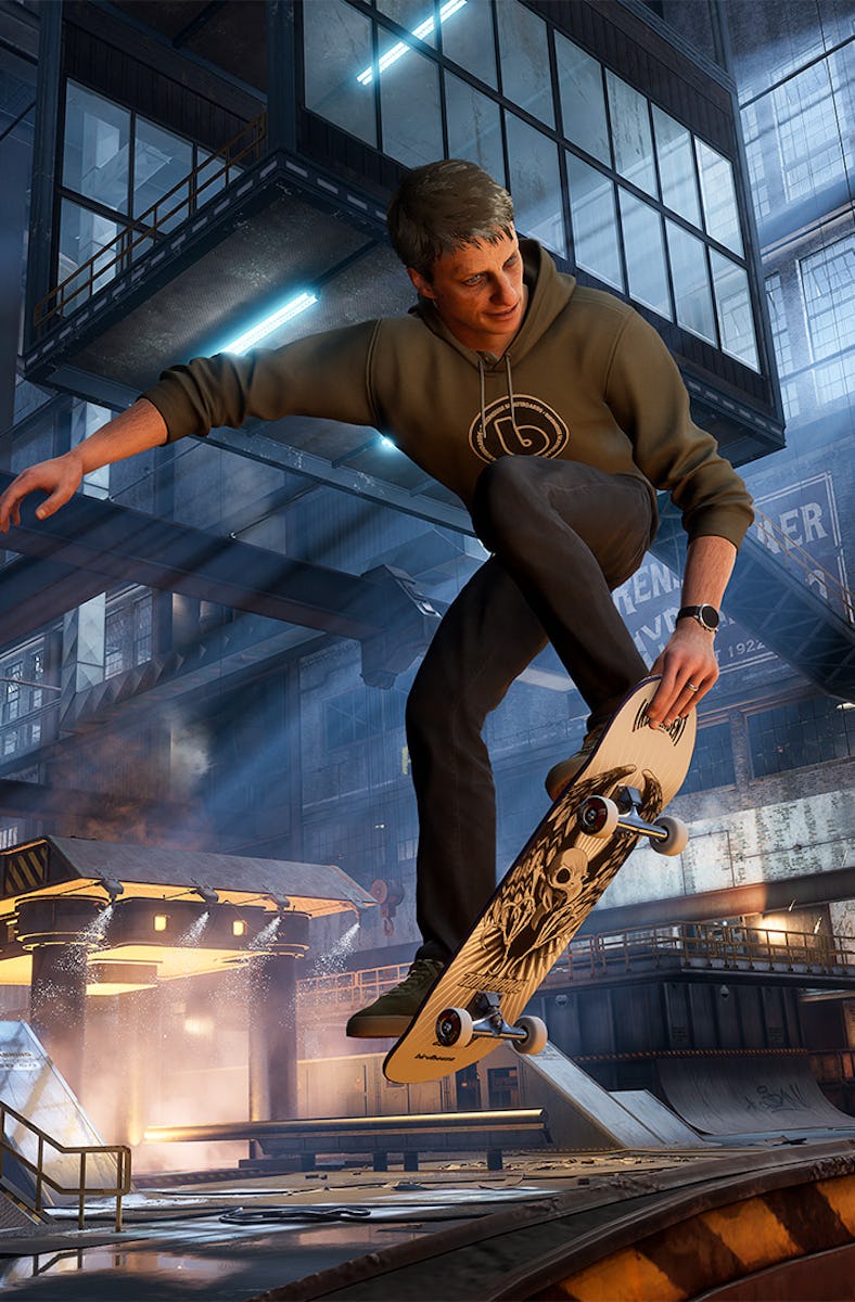 Tony Hawk performs a mid-air trick inside a skatepark, surrounded by ramps and structures, with the ...