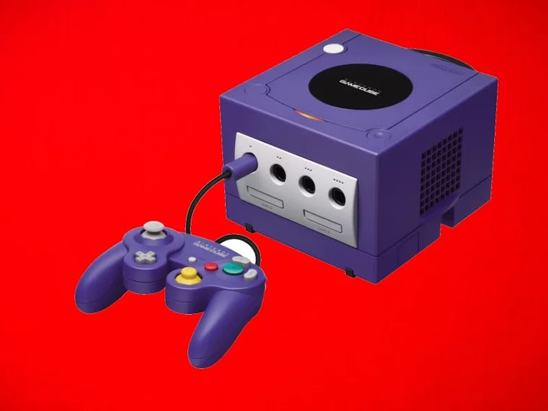 A GameCube in front of a red background