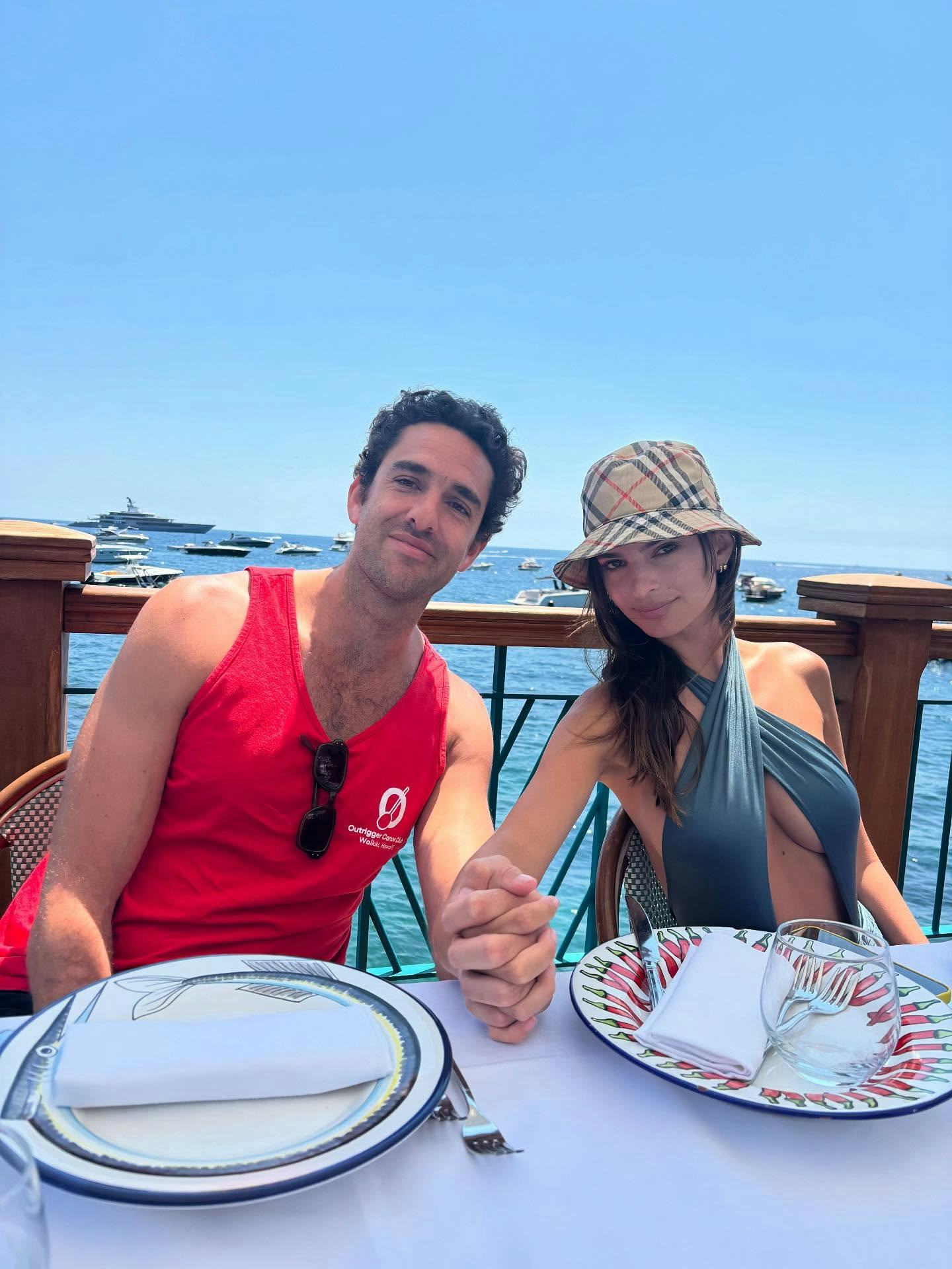 Emily Ratajkowski wears a blue cutout swimsuit. 