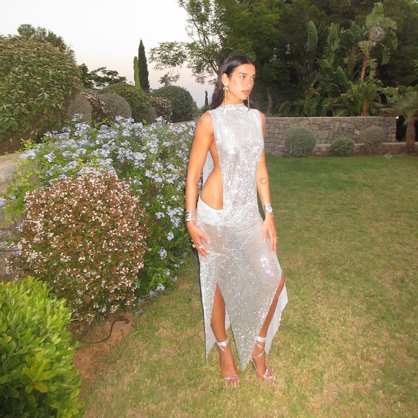 Dua Lipa wears a sparkly dress with a huge cutout.