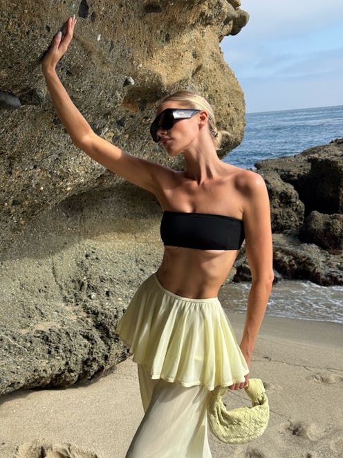 Elsa Hosk wears a black bandeau bra and butter yellow skants.