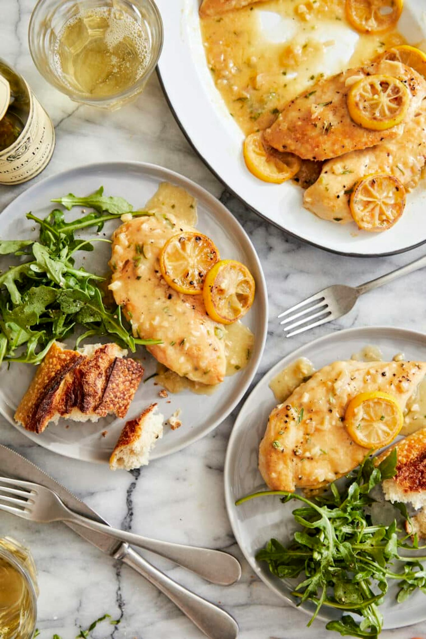 lemon chicken with greens and bread in a story about chicken breast recipes