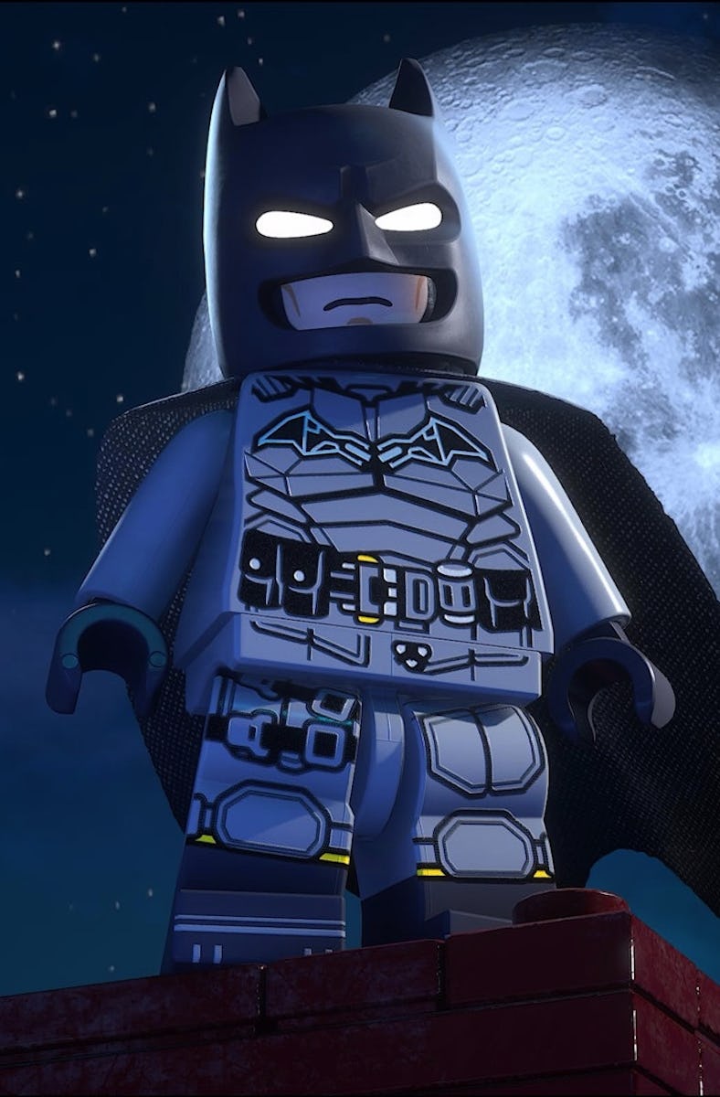 Lego Batman stands in front of a full moon.
