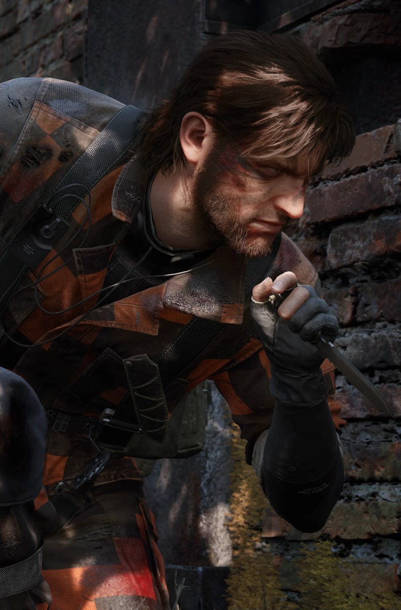 Naked Snake hiding behind a brick wall wearing red fatigues.
