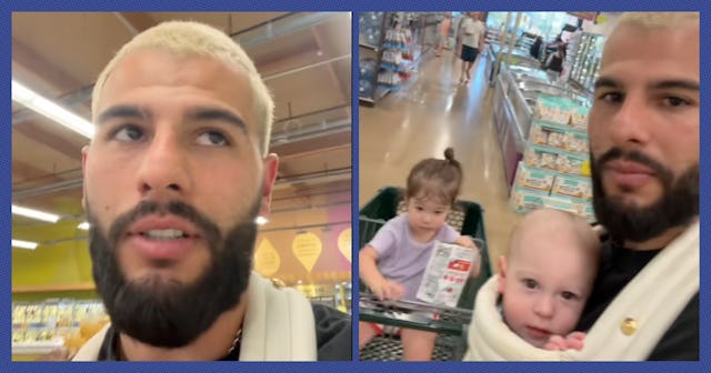 A man with a beard and blonde hair is in a grocery store, holding a baby in a carrier and pushing a ...