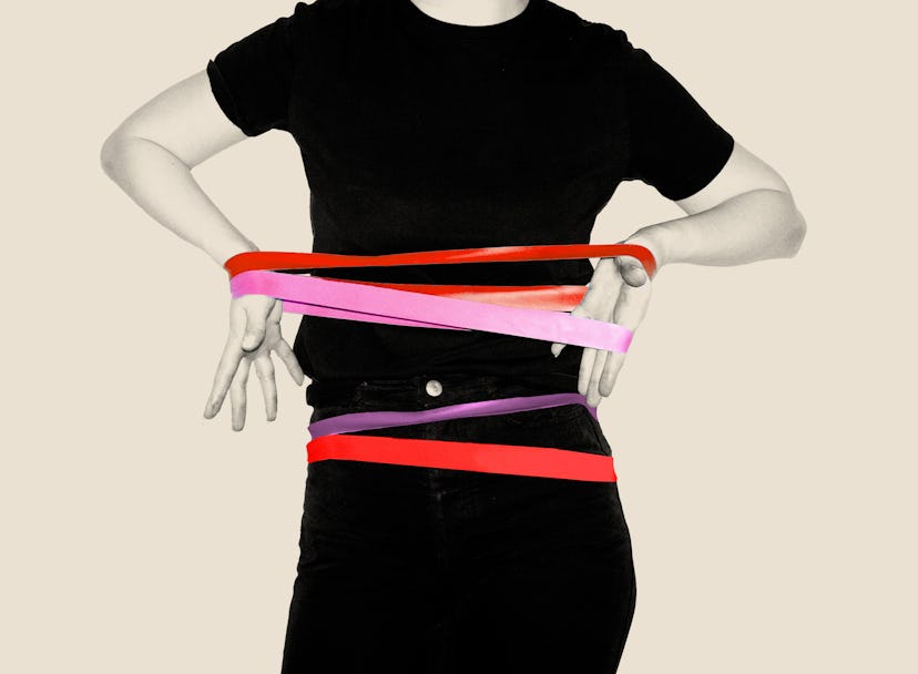 A woman wearing all black has bright, stretchy bands on her waist and forearms.