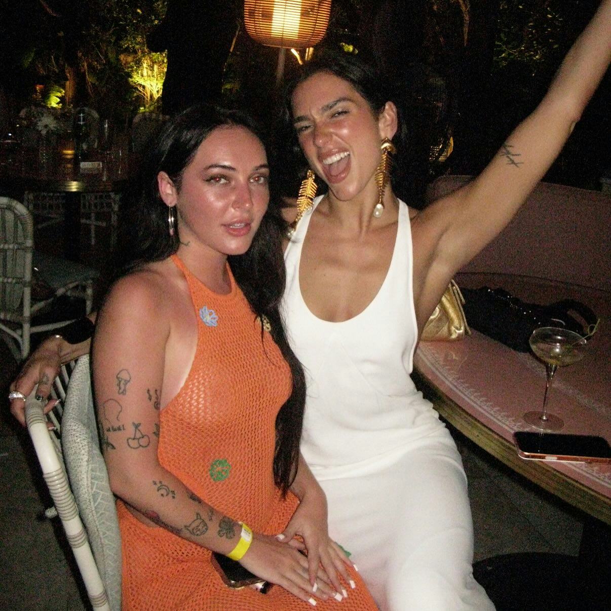 Dua Lipa wears a white dress. 