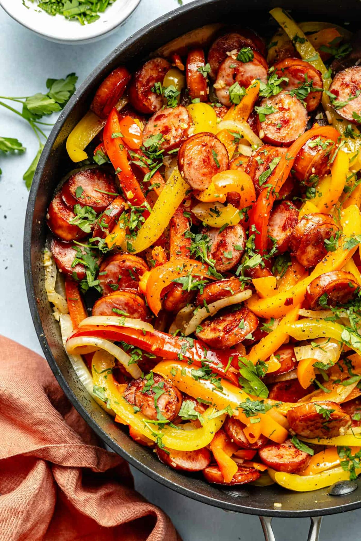 sausage and bell peppers in skillet in a story about quick and easy kielbasa recipes