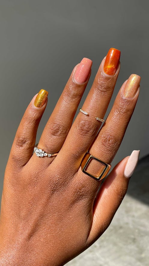 Fall 2025's hottest nail polish color trends are moody and chic.