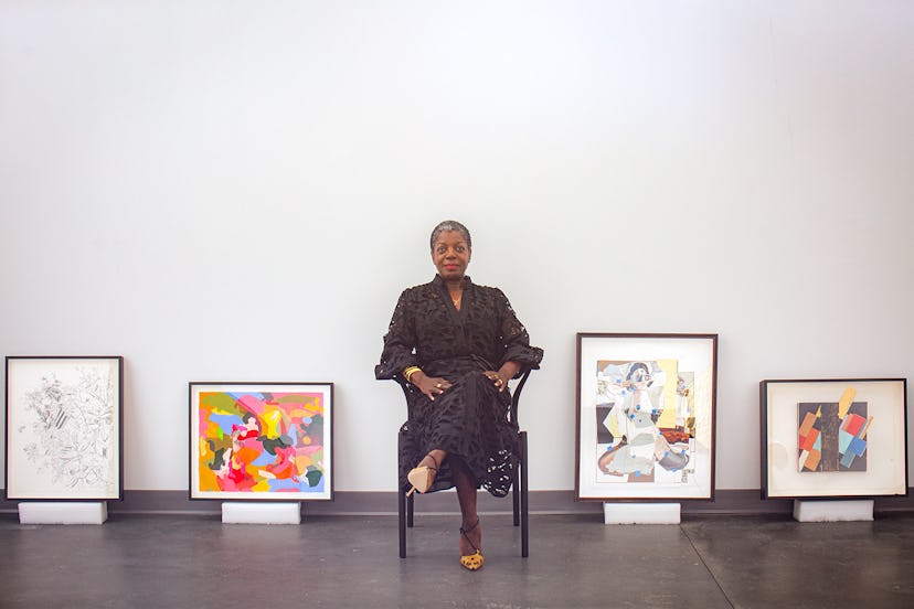 Thelma Golden seated with artwork