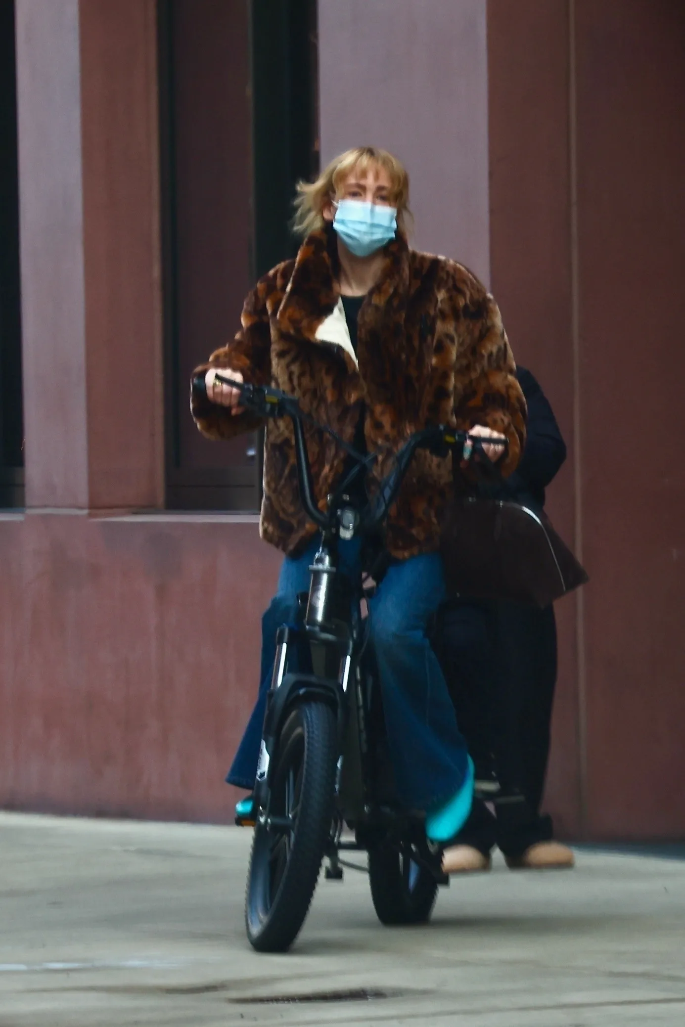 Jennifer Lawrence's Faux Fur Coat & Cult Blue Jeans Make Biking