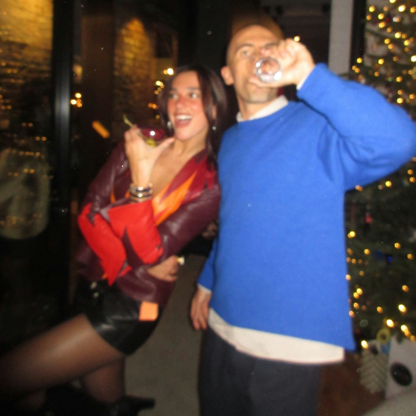 Dua Lipa wears a plunging leather top and hot pants. 