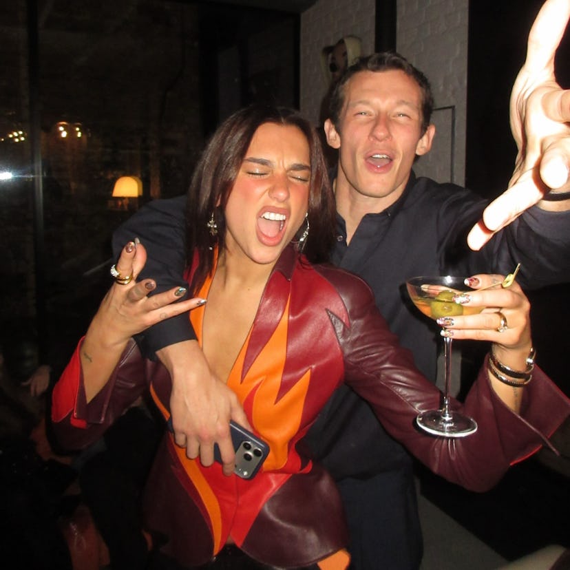 Dua Lipa wears a plunging leather top and hot pants.