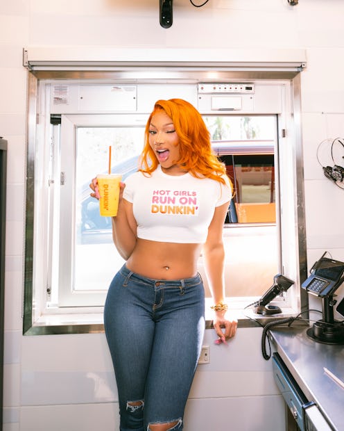 Megan Thee Stallion wears a crop top and skinny jeans.