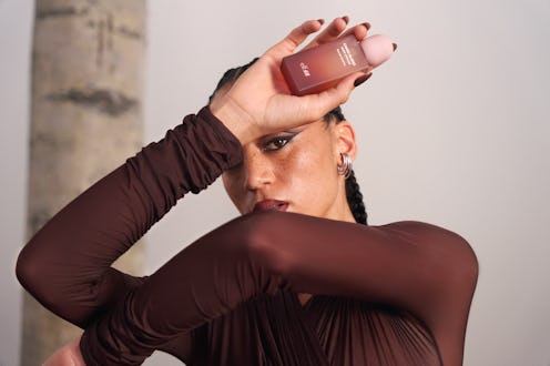 A model holds a bottle from the H&M x e.l.f. Beauty fragrance collaboration