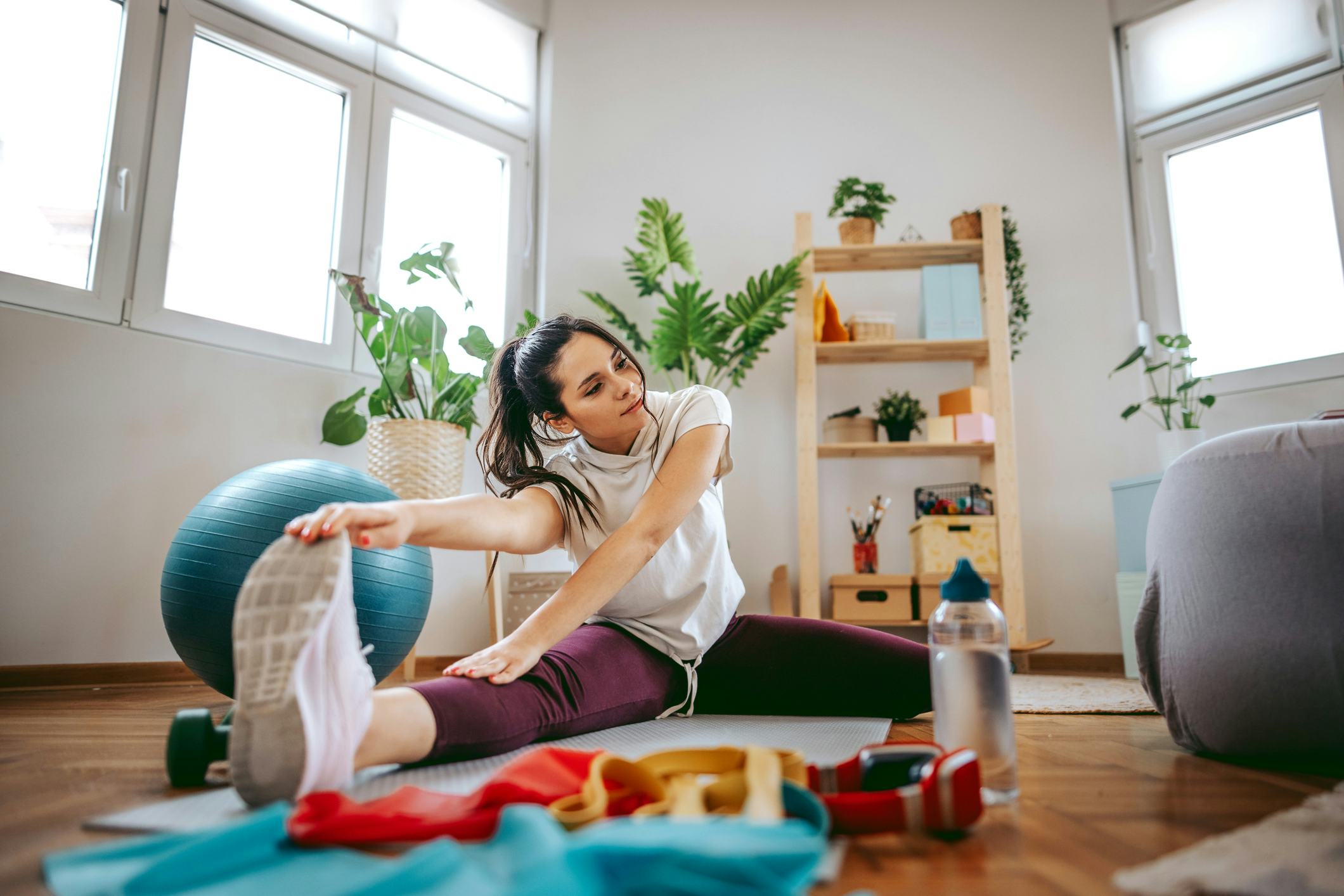 A woman works out at home.