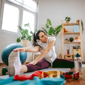 A woman works out at home.